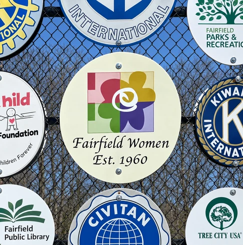Fairfield Women Est. 1960 sign displayed with other Fairfield community organization signs
